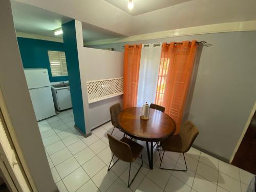 a small dining room with a table and chairs at Finest Accommodation Renfrew Place Apt # 41 4--12 Renfrew Rd New Kgn in New Kingston