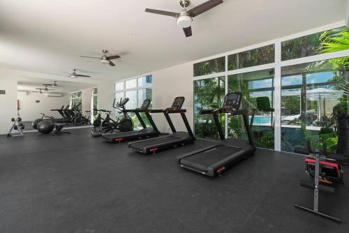 a gym with a row of treadmills and exercise bikes at Oceanfront Paradise In Akumal Beach Access in Akumal