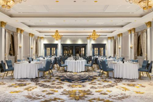 a banquet hall with tables and chairs and chandeliers at Tbilisi Marriott Hotel in Tbilisi City