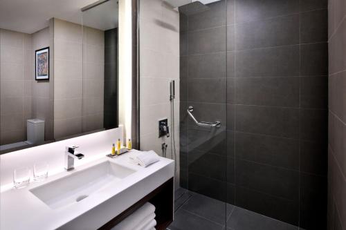 a bathroom with a sink and a shower at Riyadh Airport Marriott Hotel in Riyadh