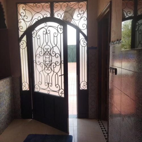an open door with a wrought iron gate at Chez Sondos in Marrakech