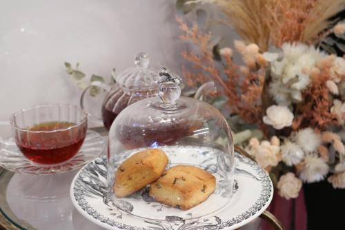 a plate with cookies and a glass dome on a table at ecrin in Awaji
