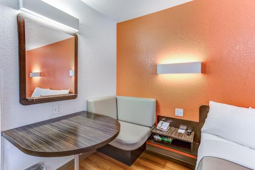 a small room with a table and a bed at Motel 6-Portland, OR - Tigard West in Tigard