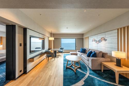 a living room with a couch and a table at Hilton Tokyo Bay in Urayasu