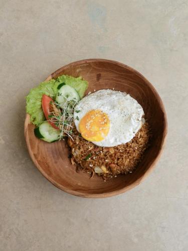 a plate of food with an egg and a salad at Sunrise Villa in Payangan