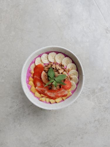 a bowl of food with fruit on a table at Sunrise Villa in Payangan