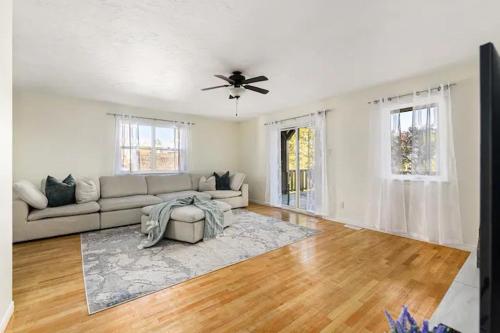 a living room with a couch and a ceiling fan at Spacious 4 bedrooms, 5 beds home - 3 Minutes to Downtown Moncton in Moncton