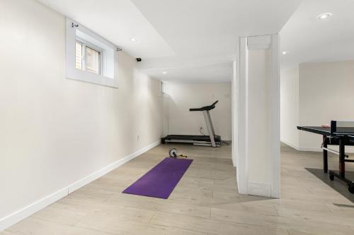 a room with a purple yoga mat and a treadmill at Spacious 4 bedrooms, 5 beds home - 3 Minutes to Downtown Moncton in Moncton