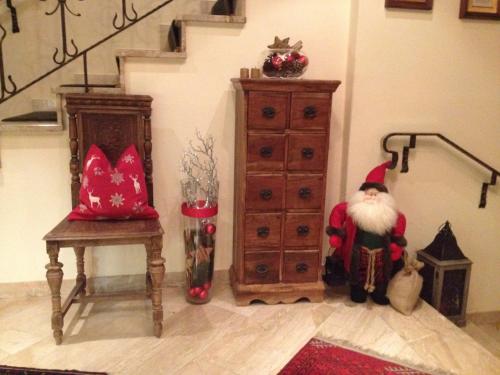 a room with santa claus sitting next to a dresser at Hotel Garni Erler in Mayrhofen