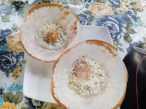 two plates of food on a white plate at Sigiri Sithru Home Stay in Sigiriya