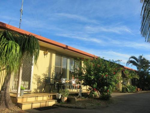 a yellow house with a table in front of it at Waterfront Wyuna in Tweed Heads