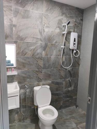 a bathroom with a toilet and a shower at Enap Machang in Macang