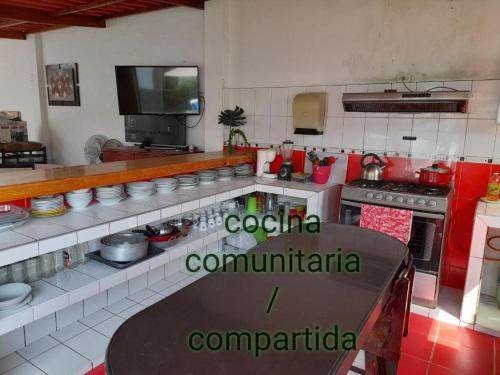 a kitchen with a table in the middle of it at Montemar Apart Hotel - Playa Huanchaco in Huanchaco