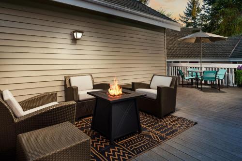 a patio with chairs and a table with a candle on it at Residence Inn by Marriott Seattle/Bellevue in Bellevue