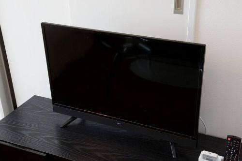 a flat screen tv sitting on top of a table at Mishuku Onna 301 in Baba