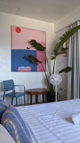 a bedroom with a bed and a potted plant at Two Bedroom Affordable Beach Front House in Boracay