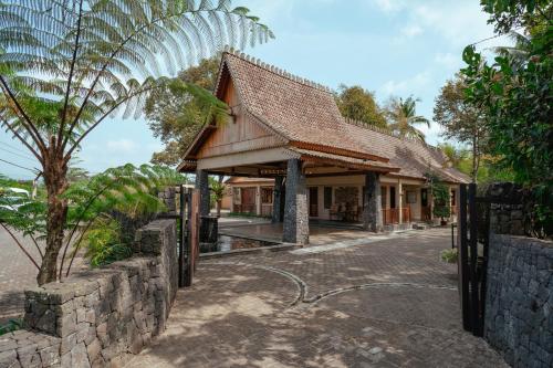 a building with a fence in front of it at d'Temanggung Villa in Temanggung