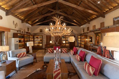 a large living room with couches and a chandelier at d'Temanggung Villa in Temanggung