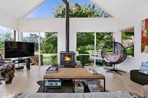 a living room with a wood stove in it at Nafplio Red Hill vineyard stunning views in Red Hill South