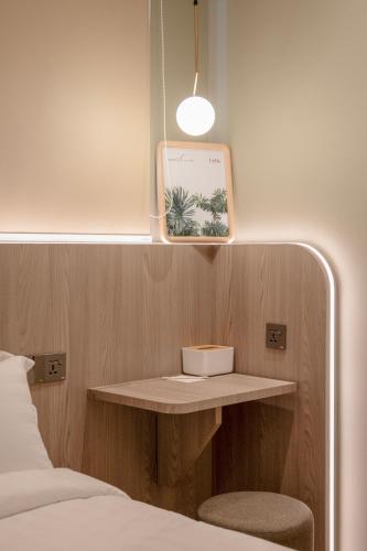 a bedroom with a bed and a shelf next to a bed at La Vie Hotel Juru in Simpang Ampat