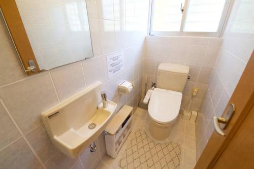 a bathroom with a toilet and a sink at AK apartment 2F in Jima