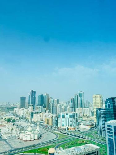 an aerial view of a city with tall buildings at Spacious 3-Bedroom Apartment near Al Khan Beach in Al Khān