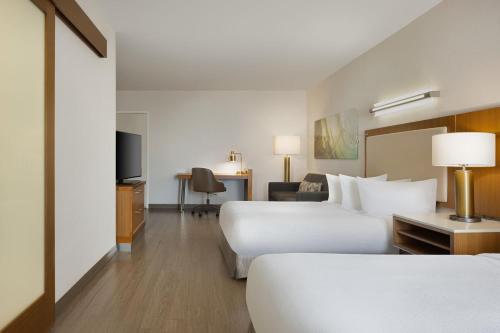 a hotel room with two beds and a television at SpringHill Suites Orange Beach at The Wharf in Orange Beach