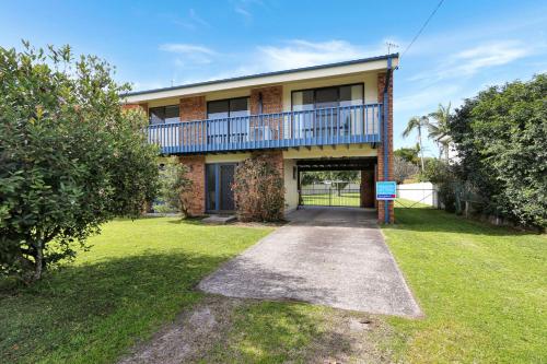 a brick building with a balcony on top of it at Pet Friendly on Pelican Close to Myall River in Hawks Nest