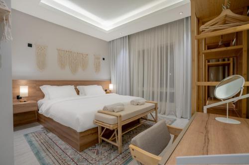 a bedroom with a bed and a desk and a chair at Layali Properties - Boho Oasis 3BR Apt - Convention and Exhibition Center in Riyadh