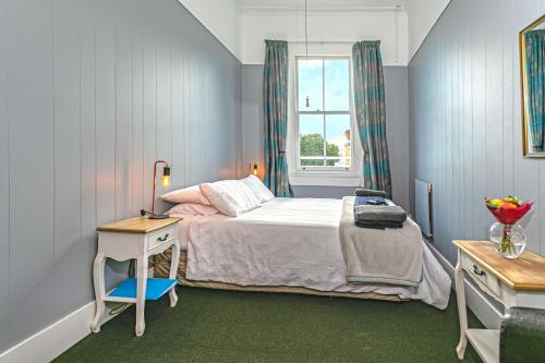 a small bedroom with a bed and a window at Lady Bowen Bed & Breakfast in Thames