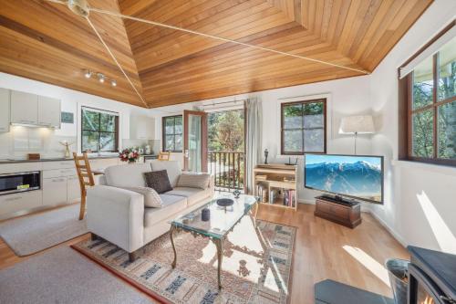 a living room with a couch and a tv at Acer Corner in Blackheath