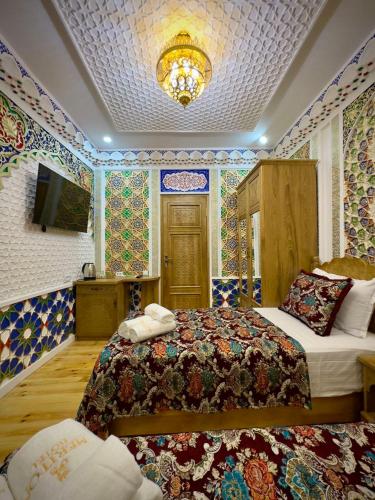 a bedroom with a bed in a room with colorful tiles at MERITON Boutique in Bukhara
