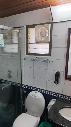 a bathroom with a toilet and a sink at Mountain Club Resort Munnar in Chinnakanal