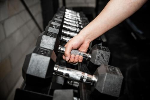a person holding a dumbbell in a gym at Foothills in Lilydale