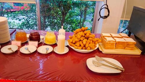 a table topped with plates of food on top at Chumphon Gardens Hotel in Chumphon