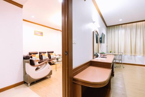 a consultation room in a clinic with a mirror at Chumphon Gardens Hotel in Chumphon