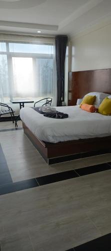 a bedroom with a large bed and a table at Key Villa in Homa Bay
