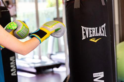 a person is wearing boxing gloves in a gym at W Scottsdale in Scottsdale