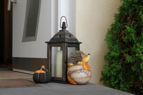 a lantern sitting next to two pumpkins on a porch at Apart Andrea in Längenfeld
