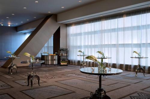 a lobby with two tables and a large window at Toronto Marriott City Centre Hotel in Toronto