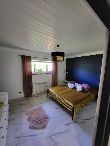 a bedroom with a bed with two pillows on it at Leśne Wzgórze nad Soliną in Bóbrka