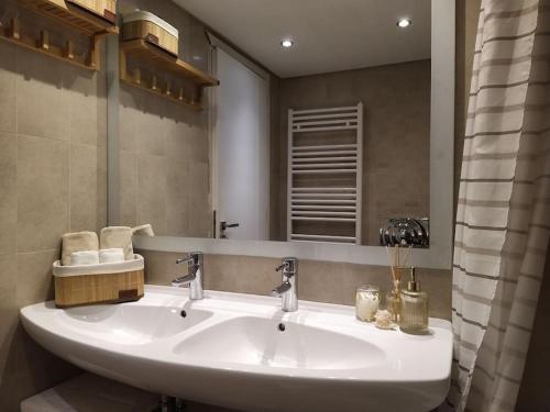 a bathroom with a white sink and a mirror at Garden house by the sea in Vari