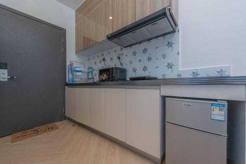 a kitchen with a counter top and a refrigerator at Lovely Condomnium on 10th floor in Nairobi