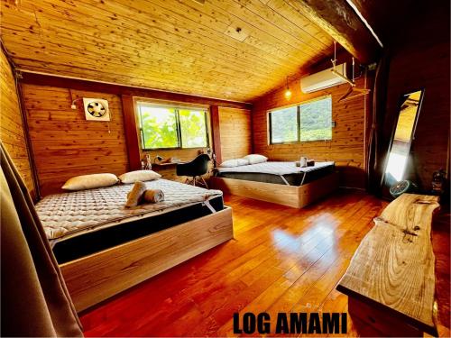 Postel nebo postele na pokoji v ubytování LOG AMAMl 1棟貸切ログハウス