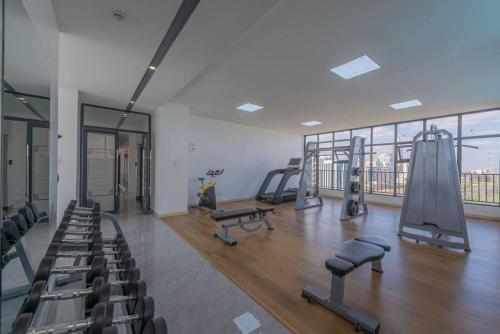 a gym with treadmills and equipment in a building at Lovely Condomnium on 10th floor in Nairobi