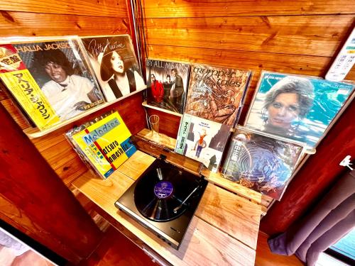 a table with a bunch of movies on it at LOG AMAMl 1棟貸切ログハウス in Setouchi