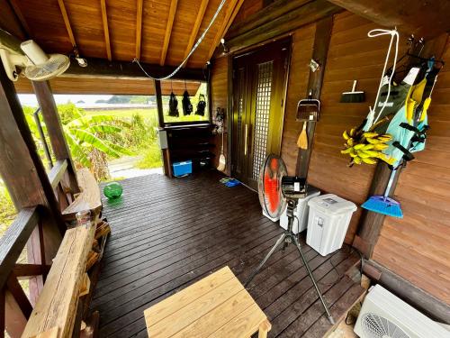 an overhead view of a porch of a wooden cabin at LOG AMAMl 1棟貸切ログハウス in Setouchi