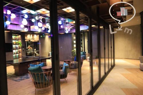 a room with a table and chairs and windows at The Central Pattaya High Floor, Pattaya City in Pattaya Central