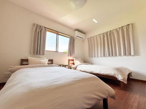 Ένα ή περισσότερα κρεβάτια σε δωμάτιο στο TAITO BEACH HOUSE