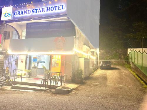 a car parked outside of a grand star hotel at night at Grand Star Hotel in Batu Ferringhi